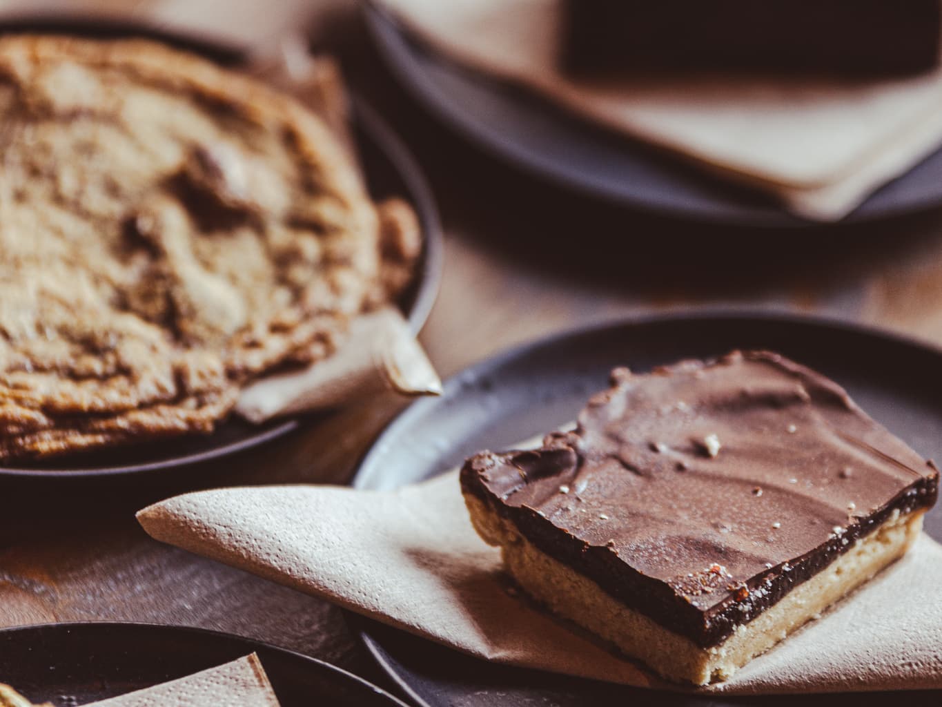 Chocolate brownie served on a plate with coffee in a cafe setting